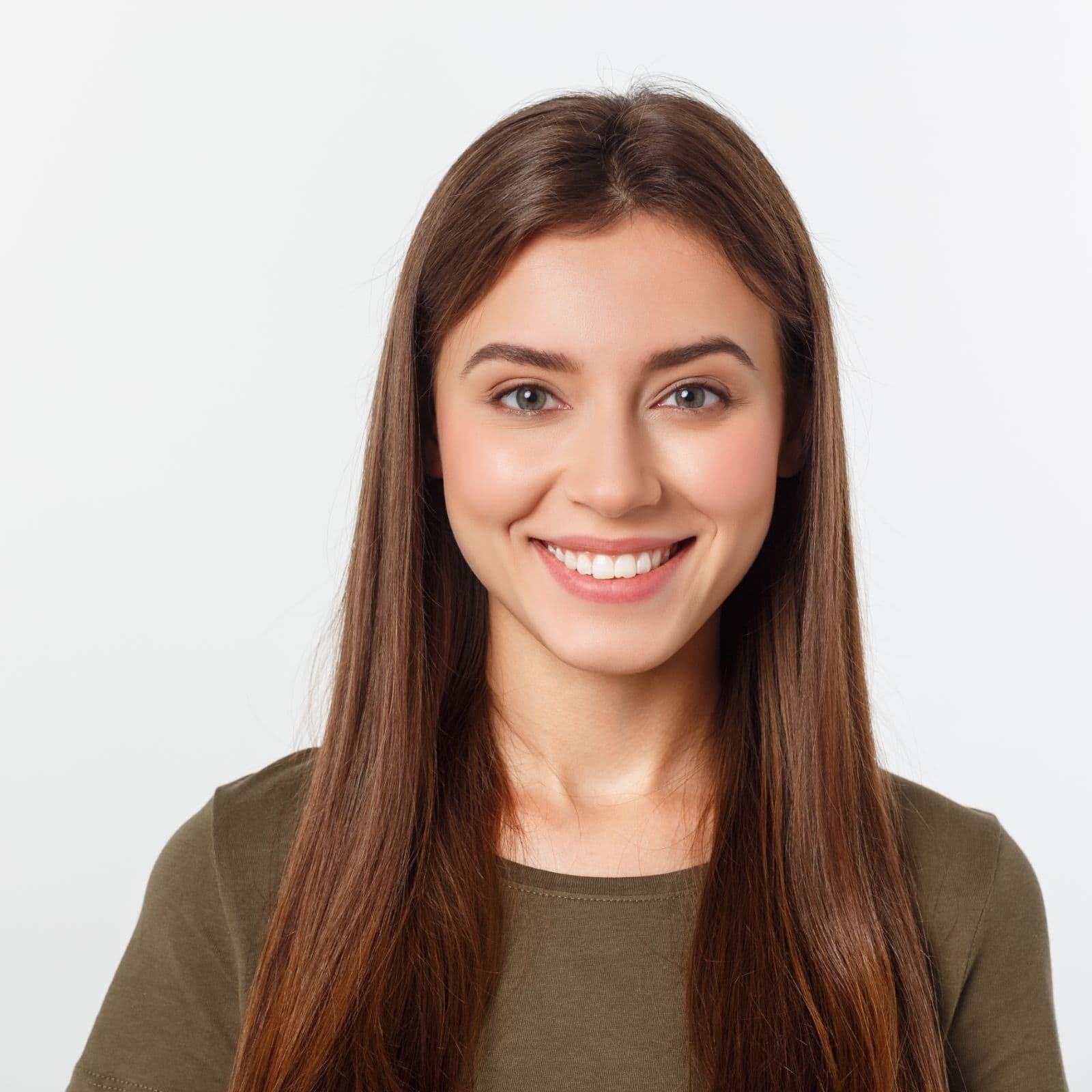 Smiling young woman with straight teeth and long brown hair, representing confidence and personalized orthodontic care at White Orthodontics.
