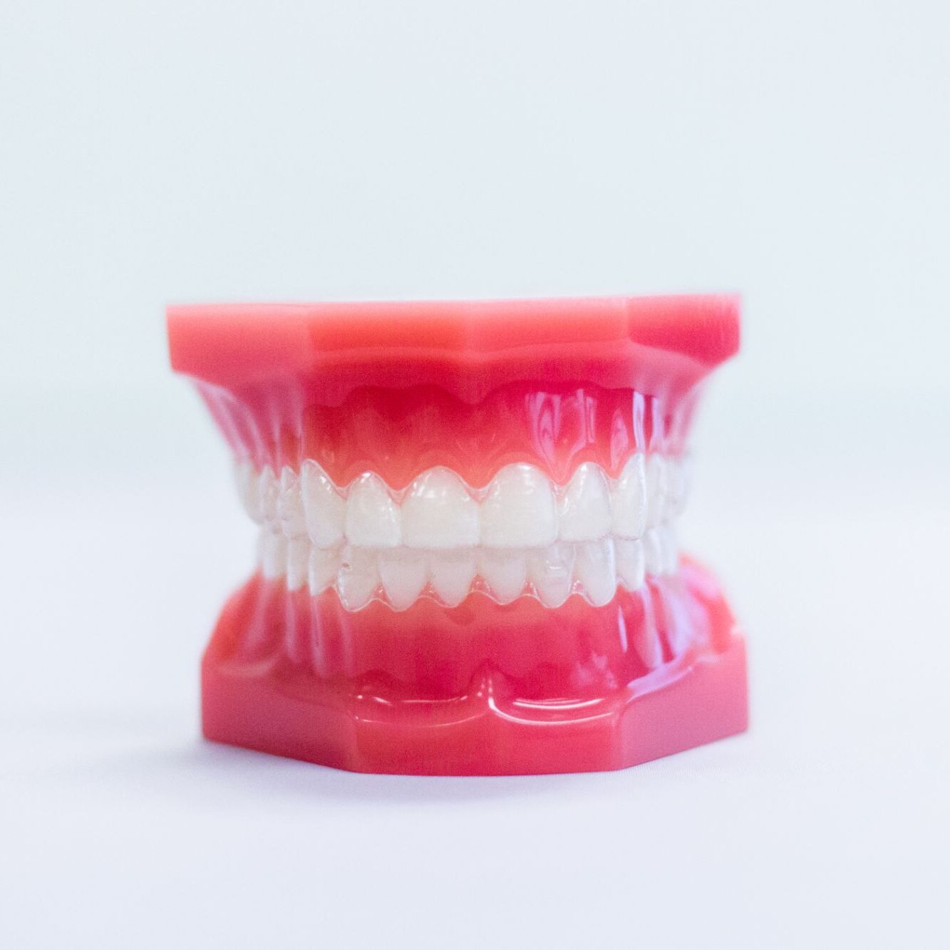 Model of teeth with clear aligners showcasing orthodontic treatment options at White Orthodontics.